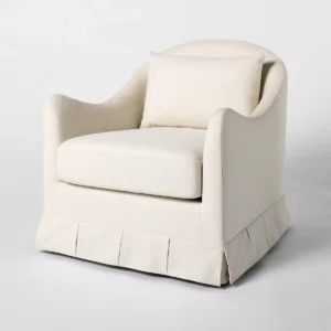 Elegant cream-colored box pleat accent chair with cushioned seat and back pillow.